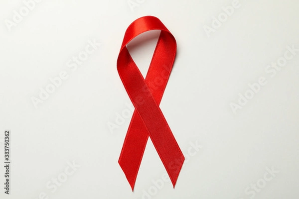 Fototapeta Red awareness ribbon on white background, close up