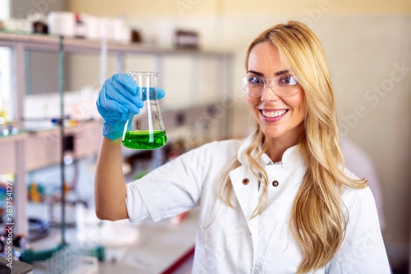 Obraz Attractive young woman scientist working in laboratory