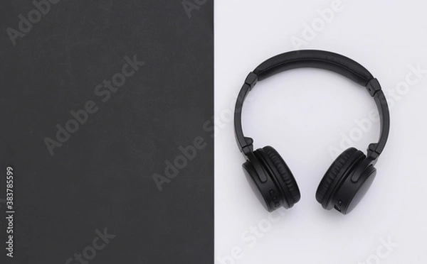 Fototapeta Wireless large stereo headphones black white background. Top view. Copy space