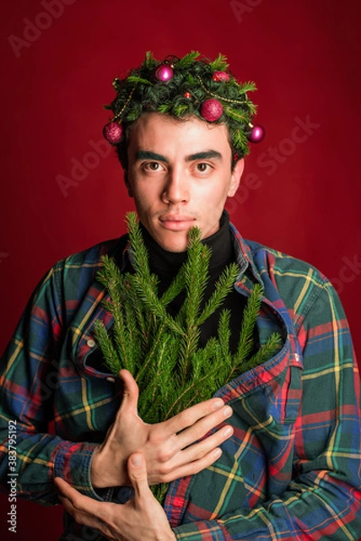 Obraz attractive man in a plaid shirt on a red background hair like a christmas tree christmas mood copyspace