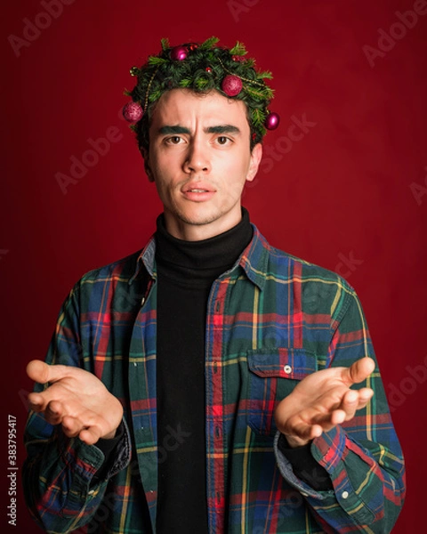 Obraz attractive man in a plaid shirt on a red background hair like a christmas tree christmas mood copyspace