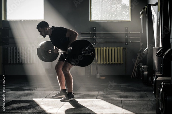 Fototapeta Man Do Exercise on Arms With Dumbbell .