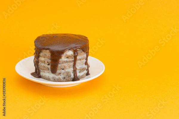 Obraz Chocolate cake with streams on a plate. Halloween concept, trick or treat. Handmade cooking, sweets with flows down. Brownies with cream. Orange background, copy space for text. Selective focus, blur.