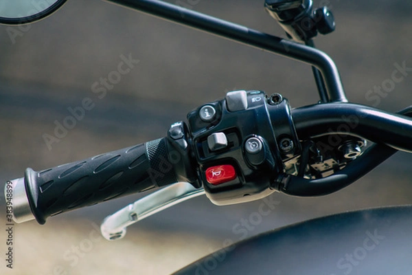 Obraz Closeup of a motorcycle parked in the streets of the city center of the metropolitan area
