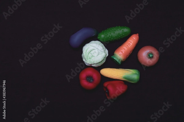 Fototapeta Miniatures of vegetables, fruits and berries on a white background. Plastic toy