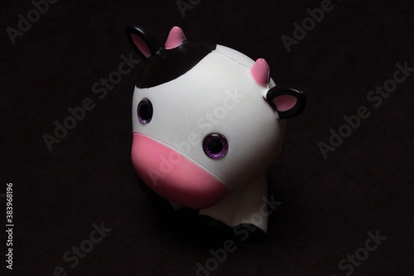 Fototapeta Soft toy cute cow on a dark background.