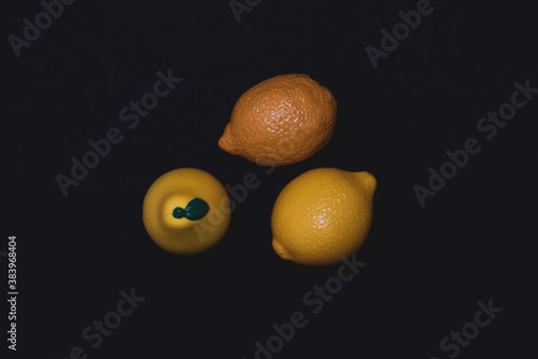Fototapeta Photos of toy fruits on a dark background. Plastic toy