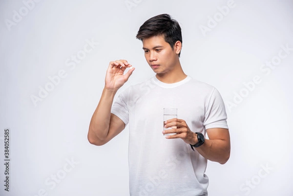 Fototapeta Men who are sick and are about to take antibiotics