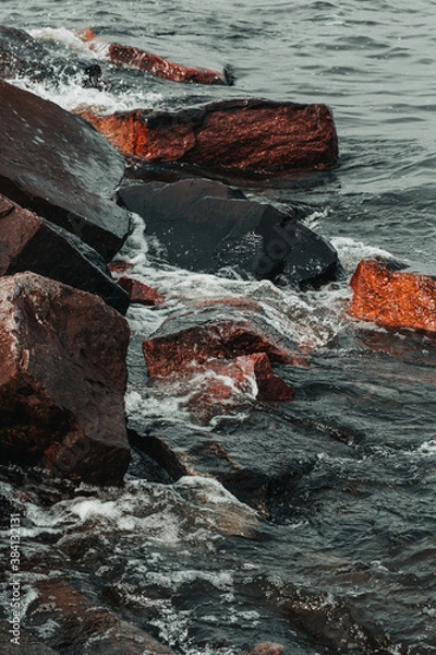 Obraz waves hitting stones on the shore in the black sea during a storm