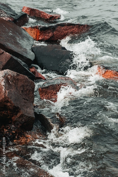 Obraz waves hitting stones on the shore in the black sea during a storm