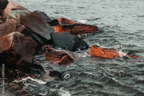Obraz waves hitting stones on the shore in the black sea during a storm