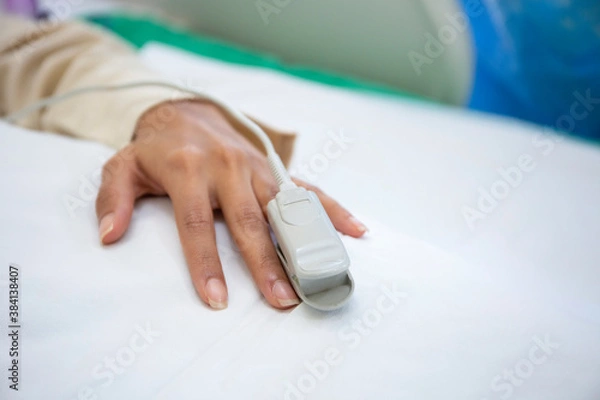 Obraz Pulse oximeter on the patient's hand. 