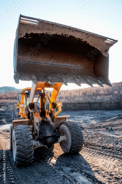 Fototapeta Wheel loader during earthworks in mountainous area - Mining