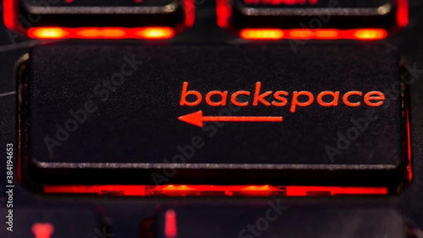 Obraz Black keyboard backspace key with red backlight
