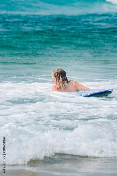 Obraz Woman with surfboard in waves of Atlantic Ocean