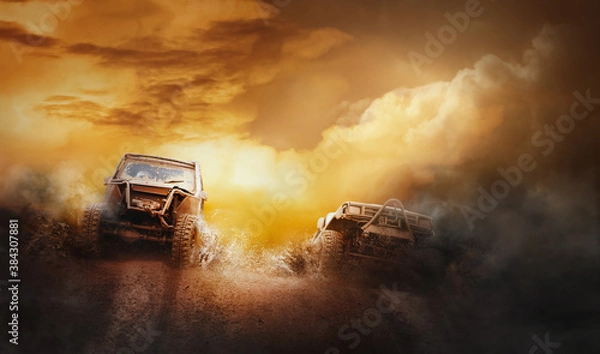 Fototapeta Two off road vehicles coming out of a mud hole hazard in off-road  competition.