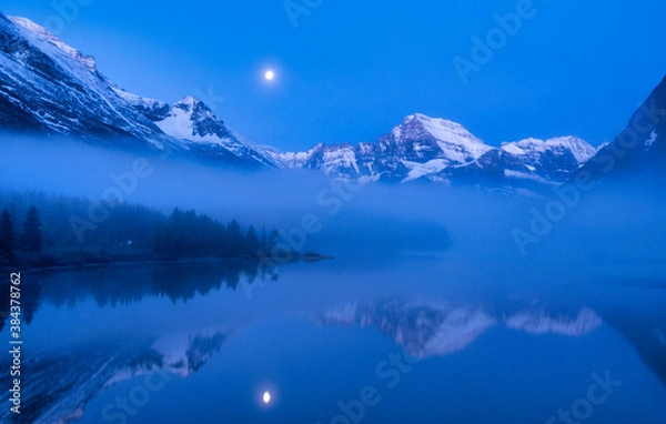 Obraz Blue Light and Lake Mirror of Moon, Clouds and Mountains of Glacier National Park