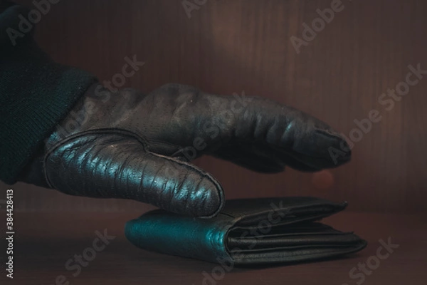 Fototapeta Thief has your wallet.man hand wallet and money on table

