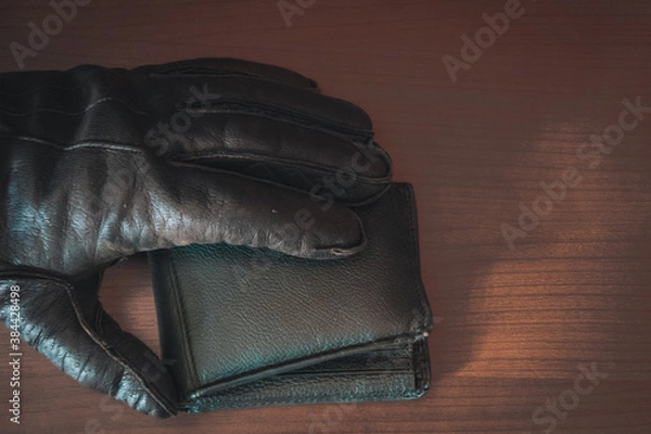 Fototapeta Thief has your wallet.man hand wallet and money on table
