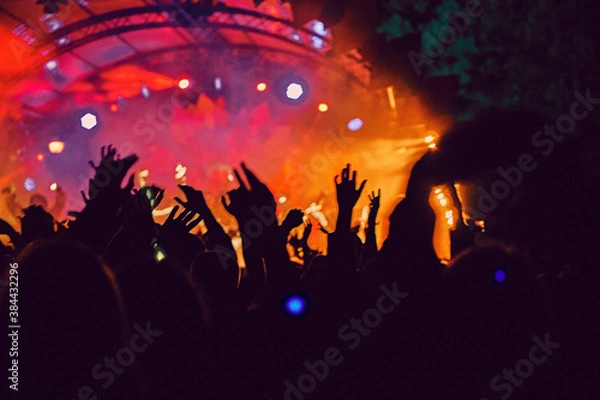 Obraz Abstract blur atmosphere: happy people enjoying outdoor music festival concert, raised up hands and clapping of pleasure, active night life concept, play of light and shadow on the stage