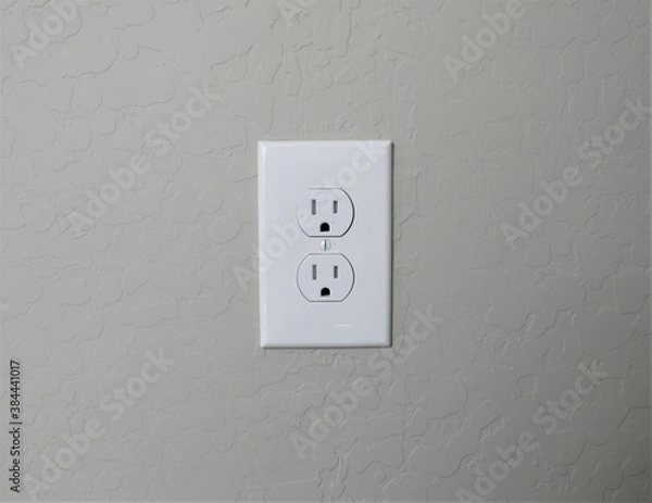 Obraz A white American electrical outlet on a stucco wall in southwest America