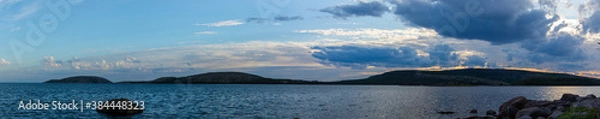 Fototapeta Seascape, marine coastline with a rocky shore, cloudy sky in the evening. Twilight on the White sea. Horizontal HDR panorama.