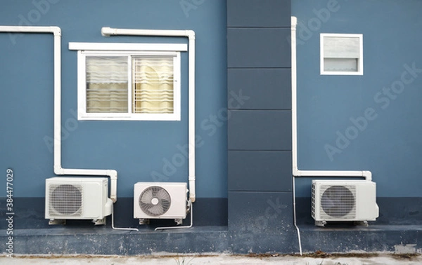 Fototapeta air compressor or air condenser unit located on concrete floor of home and wayside of road / dirty air compressor concept
