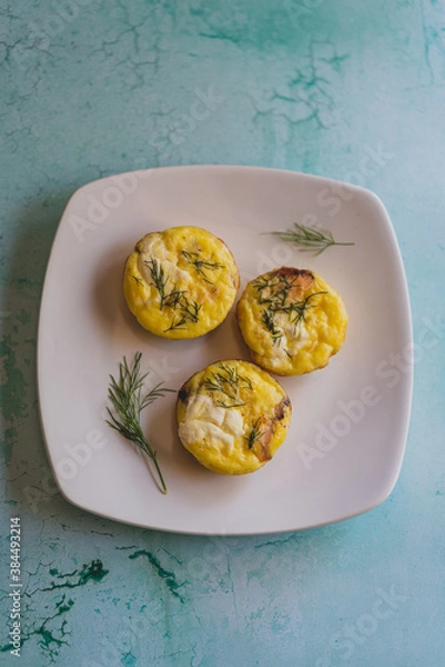 Obraz overhead photo of baked egg bites with dill on white plate