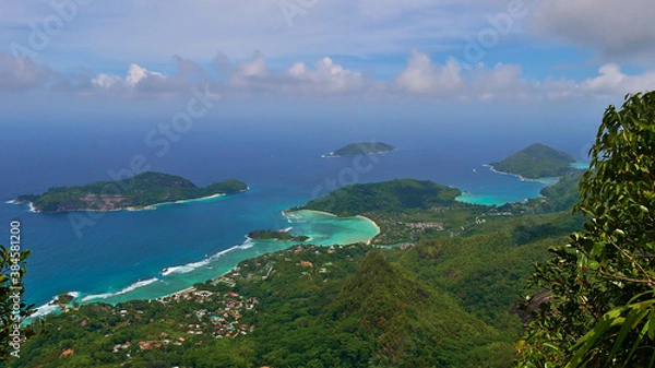 Fototapeta Panorama view from the top of mountain Morne Blanc, Mahe, Seychelles over the northwestern coastline of the island with tropical beach Anse l'Islette and Port Launay with turquoise colored water.