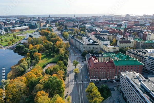 Fototapeta Aerial view of beautiful colorful old buildings in Helsinki, Finland. Fall color trees, park, sea shore and sunshine.