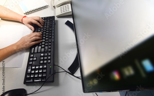 Fototapeta person typing on a keyboard