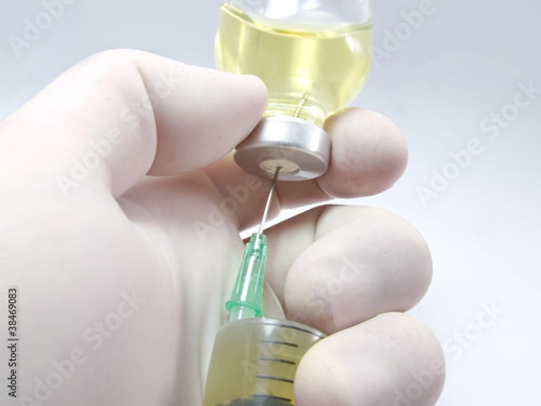 Obraz Hand, a syringe and vial