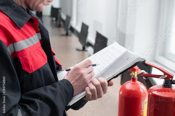 Fototapeta Engineer Professional are Checking A Fire Extinguisher Using Clipboard or checking Industrial fire control system,Fire Alarm controller, Fire notifier, Anti fire.System ready In the event of a fire.