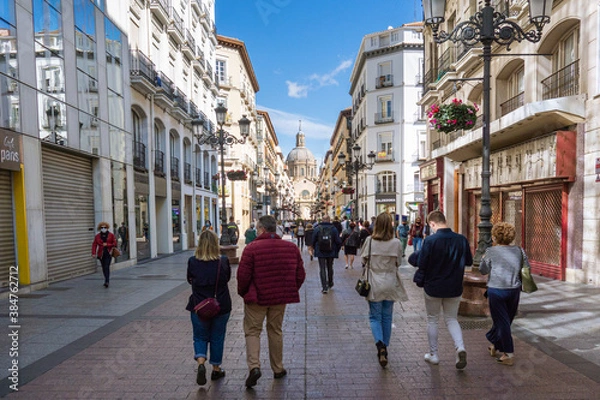 Obraz Alfonso I pedestrian street with the Basilica of Our Lady of Pilar in the background during the weekend of celebration of the patron saint festivities with people walking 