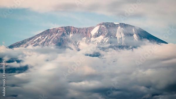 Fototapeta Kilimanjaro mountain peaking from clouds