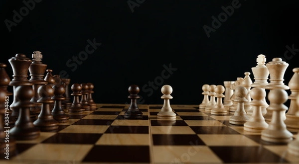 Obraz chess pieces on black background