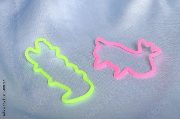 Obraz Pink and green Bracelets bandz with animals forms on blue tissu