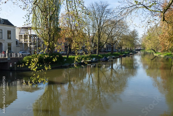 Fototapeta The canal or Singel in Utrecht The Netherlands on a sunny spring day with trees and boats