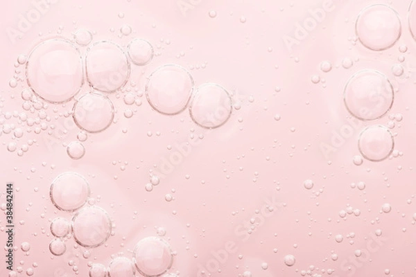 Obraz Transparent texture of moisturizing serum on a pink background. Gel water lotion for skincare. Cosmetic liquid beauty product with retinol and vitamins for face and body skin care.
