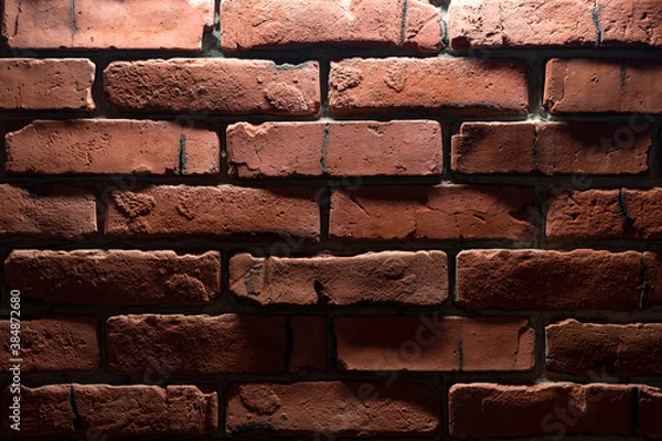 Obraz rough red brick wall lit from above