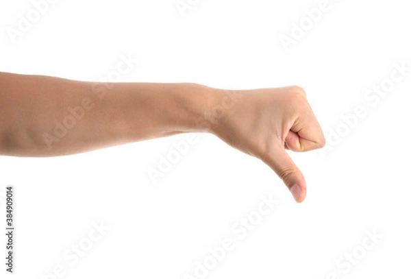 Obraz A hand making a thumbs down gesture in front of a white background