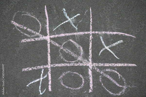 Fototapeta Noughts and crosses drawn with crayons on the asphalt
