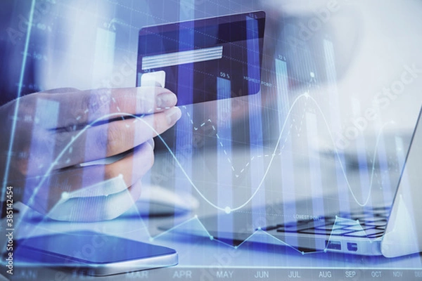 Fototapeta Multi exposure of woman on-line shopping holding a credit card and financial graph drawing. Stock market E-commerce concept.