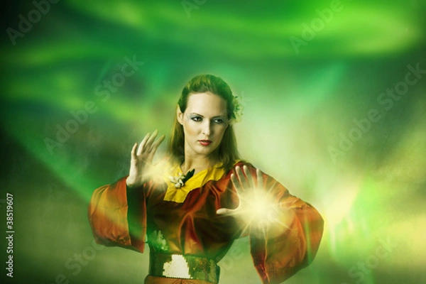Obraz Young woman elf or witch making magic.