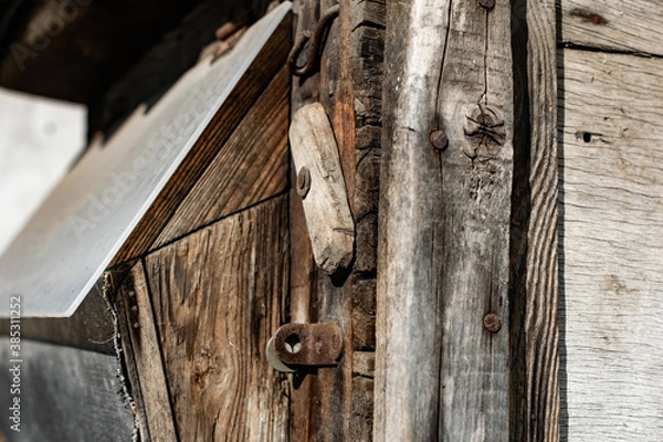 Fototapeta Old vintage door handles. Rusty metal locks and latches. Protective devices for wooden yard gates