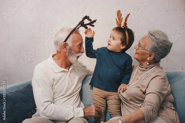Obraz Old couple waring masks, looking through window
