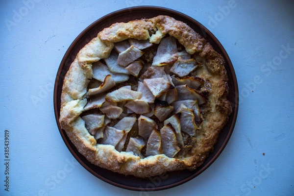 Fototapeta a pear pie on a clay plate