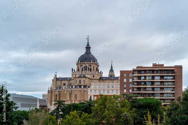 Fototapeta Skyline of Almudena Cathedral of Madrid. Exterior view from Vistillas Park at sunset