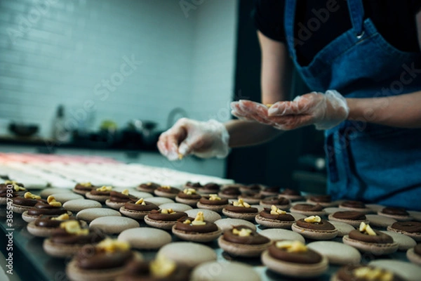 Fototapeta pastry chef making macarons with peanut inside