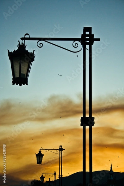 Obraz Retro street lamps on the Roman bridge in Ponte de Lima, Portugal. Beautiful evening sky.